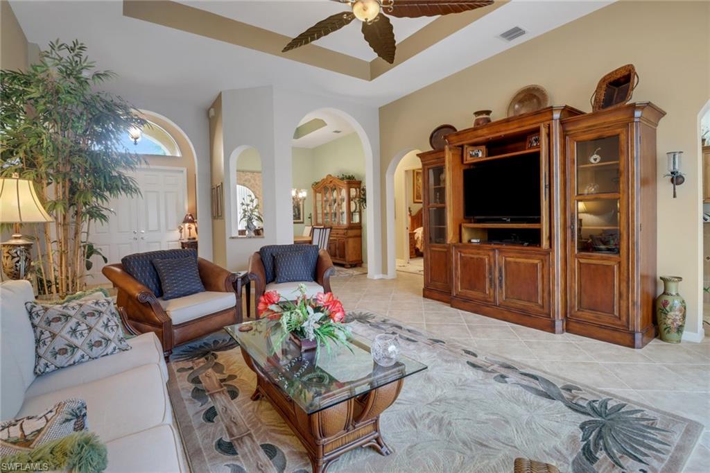 20531 Foxworth Circle Estero, FL 33928 - Photo 6 of 50 Tiled living room with ceiling fan and a raised ceiling