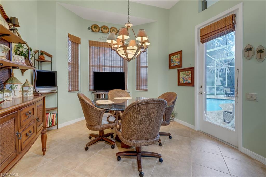 20531 Foxworth Circle Estero, FL 33928 - Photo 7 of 50 Tiled dining space with an inviting chandelier