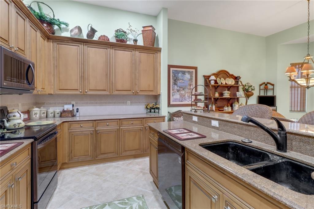 20531 Foxworth Circle Estero, FL 33928 - Photo 9 of 50 Kitchen featuring sink, light stone counters, electric stove, black dishwasher, and light tile patterned flooring