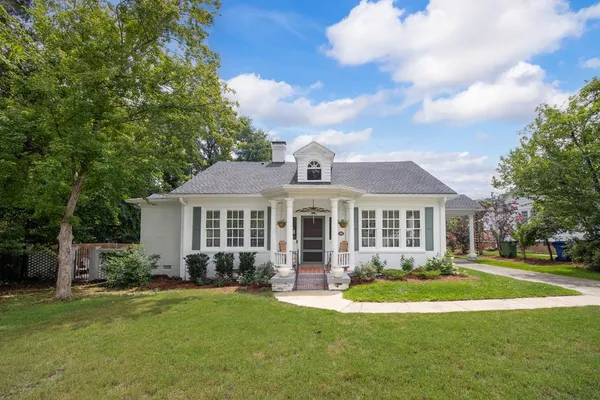 a front view of a house with a garden