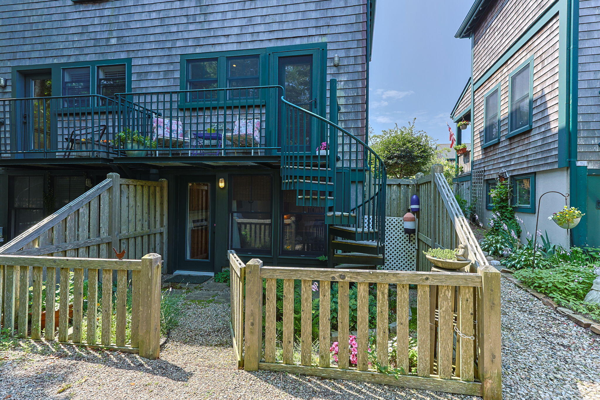 3 Meadow Road, Unit 2 Provincetown, MA 02657 - Photo 21 of 26 a view of house with a small yard and wooden fence
