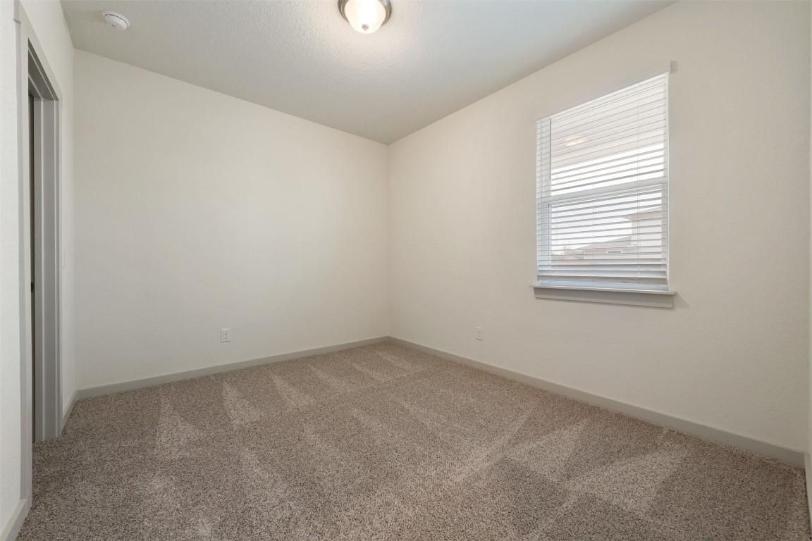 220 Deserti Road Leander, TX 78641 - Photo 12 of 16 Carpeted spare room with a smoke detector and baseboards