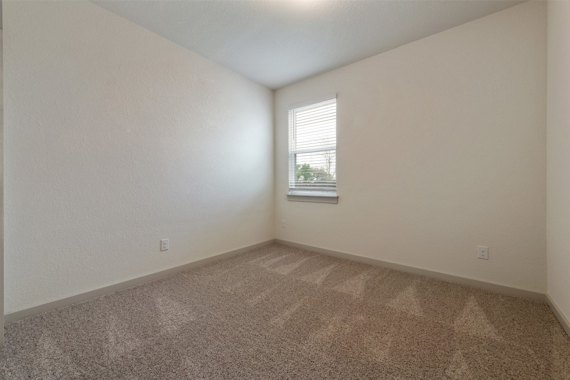 220 Deserti Road Leander, TX 78641 - Photo 13 of 16 Unfurnished room with light colored carpet and vaulted ceiling