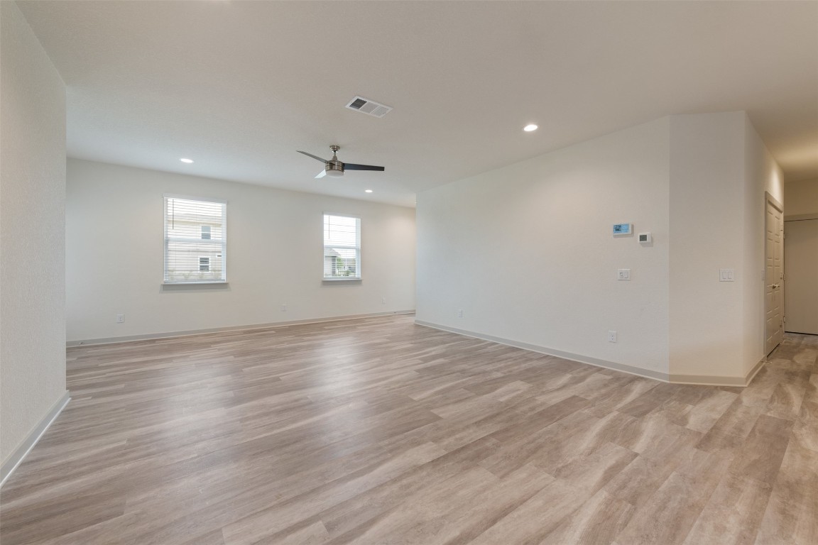 220 Deserti Road Leander, TX 78641 - Photo 5 of 16 Empty room with light wood-type flooring, recessed lighting, and a ceiling fan