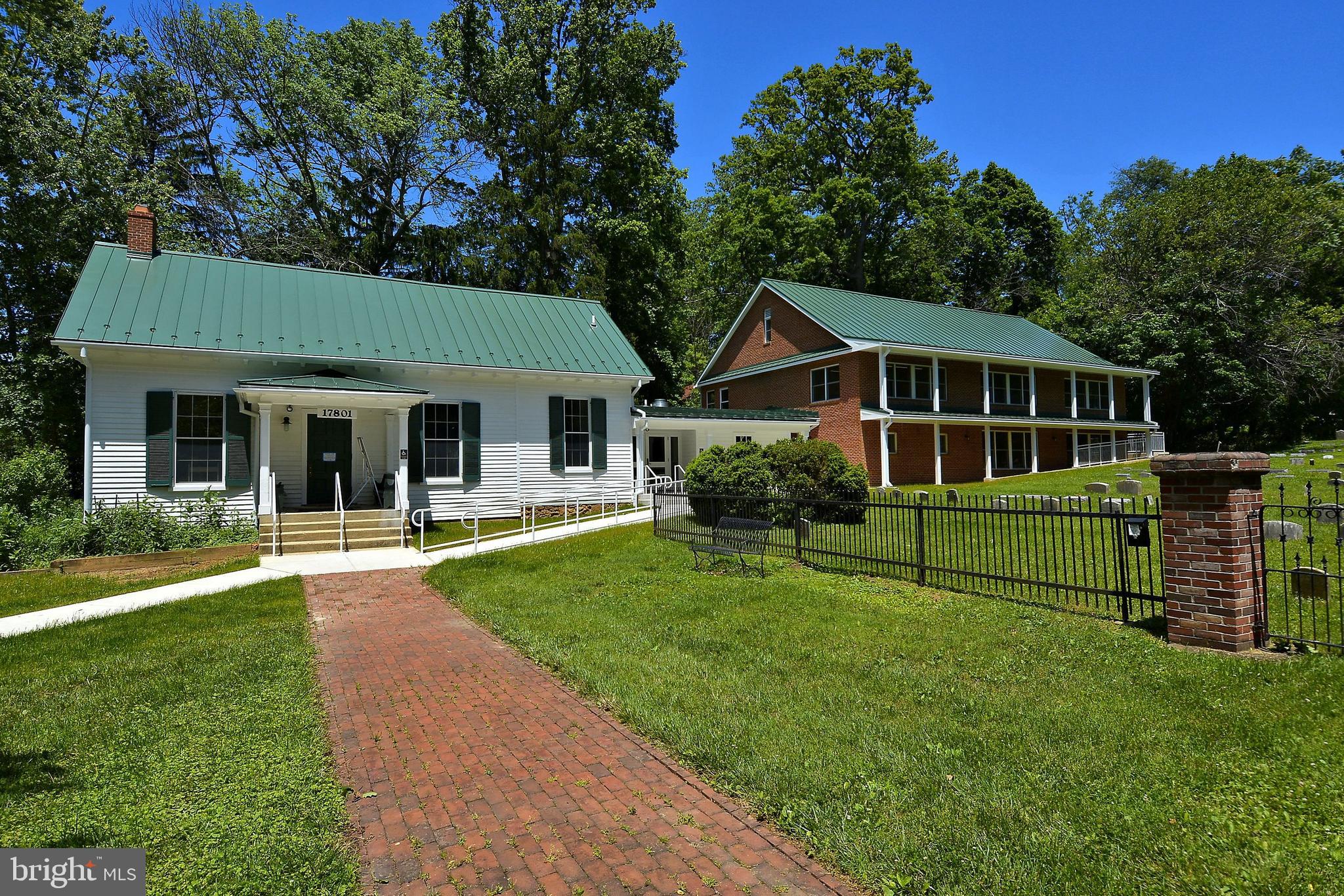 1049 Windrush Lane, Unit 2 Sandy Spring, MD 20860 - Photo 49 of 59 a front view of a house with a garden
