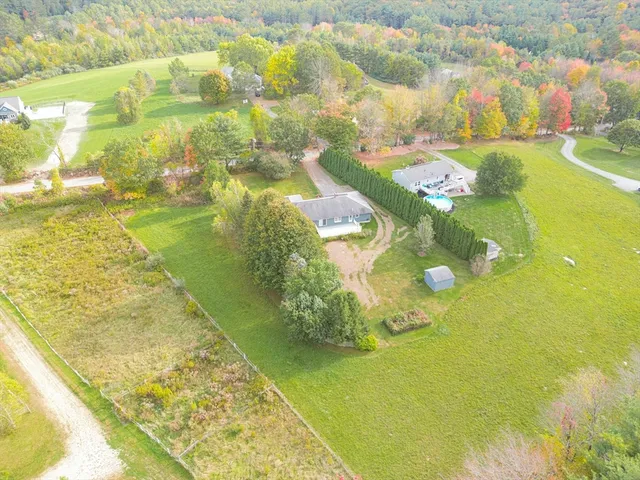 a aerial view of a house with pool table and chairs