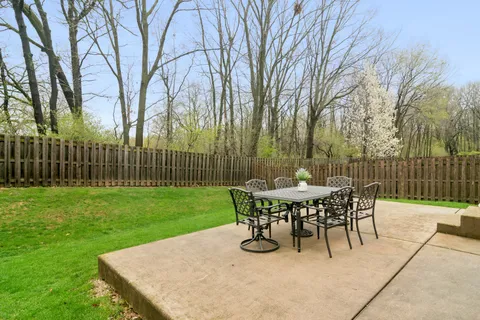 a view of a dinning table and chairs on the deck