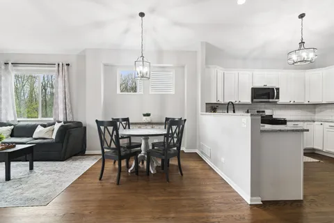 a view of a dining room with furniture window and wooden floor