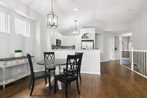 a view of a dining room with furniture and wooden floor