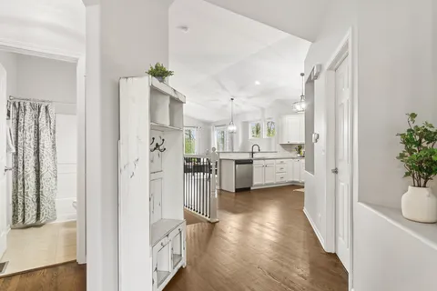 a view of a kitchen with furniture and wooden floor
