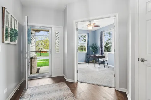a view of a hallway with dining room and stairs