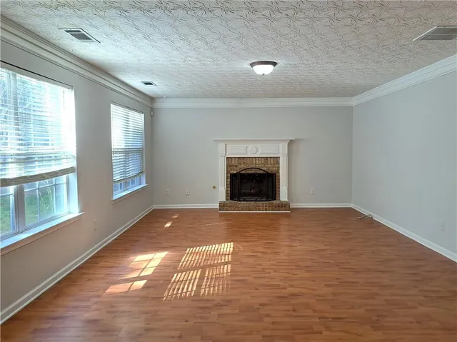 a view of empty room with a fireplace