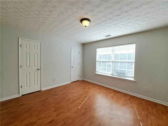 a view of a livingroom with wooden floor and a window