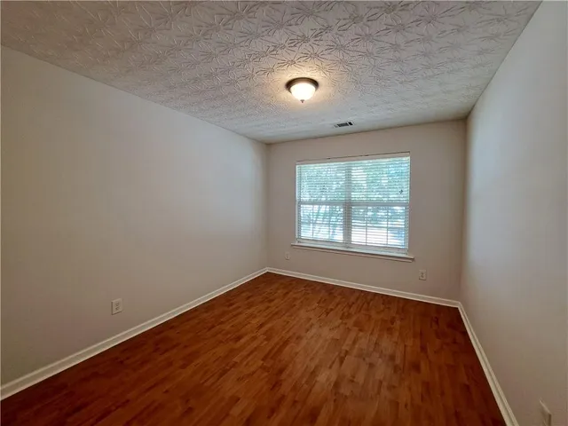 a view of an empty room and wooden floor