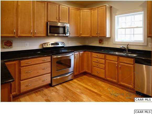 0 Timber Ridge, Unit 2 Gordonsville, VA 22942 - Photo 9 of 19 a kitchen with granite countertop wooden cabinets and a stove top oven