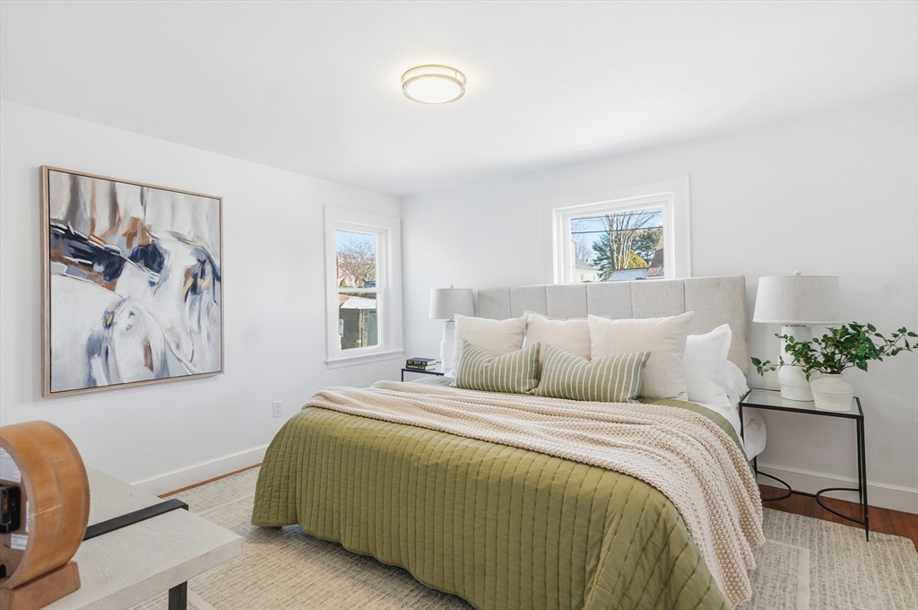 29 Puritan Road Watertown, MA 02472 - Photo 12 of 33 a bedroom with a large bed and a painting on the wall