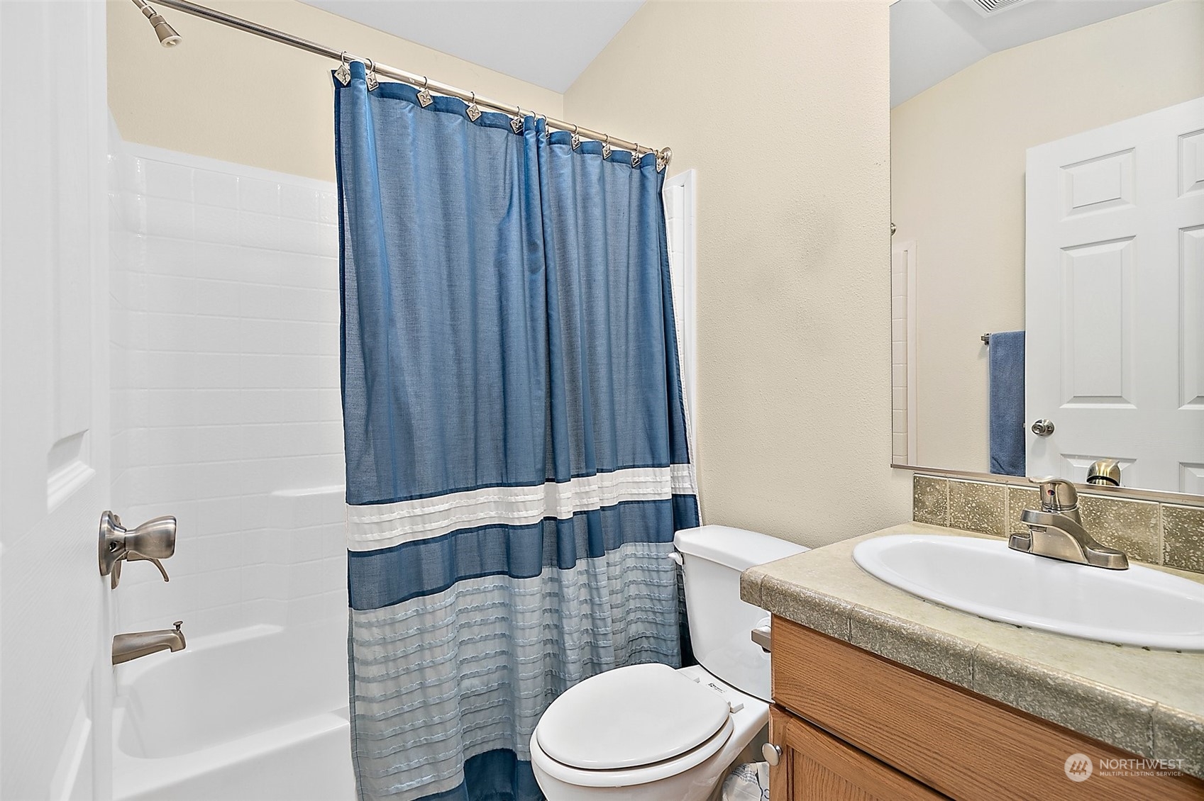 2101 South 324th Street, Unit 32 Federal Way, WA 98003 - Photo 18 of 30 a bathroom with a granite countertop bathtub sink vanity mirror and toilet