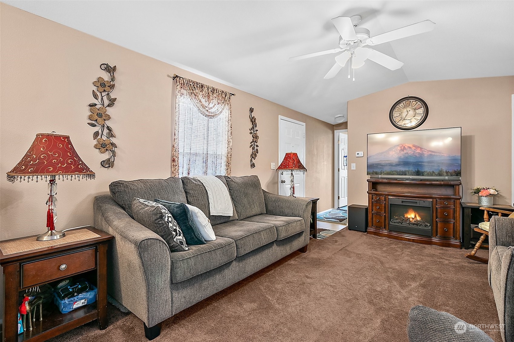 2101 South 324th Street, Unit 32 Federal Way, WA 98003 - Photo 4 of 30 a living room with furniture a flat screen tv and a fireplace