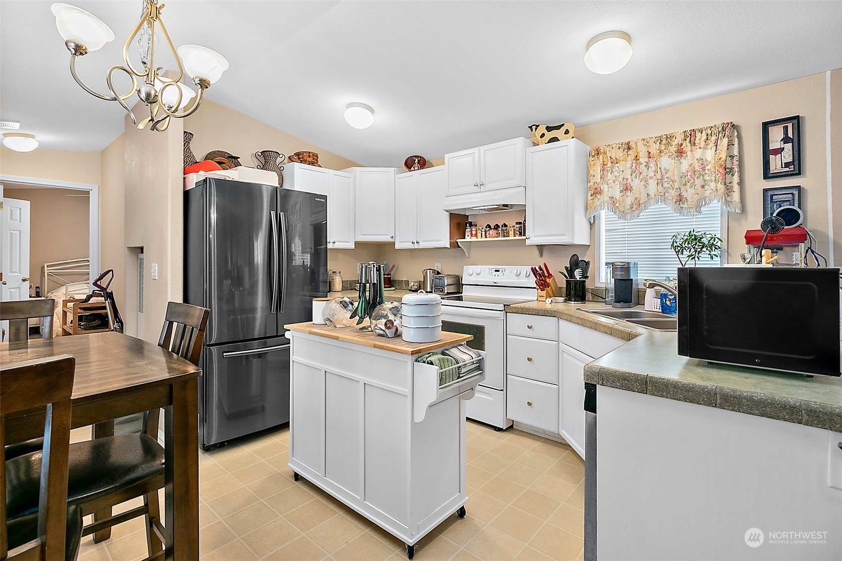 2101 South 324th Street, Unit 32 Federal Way, WA 98003 - Photo 8 of 30 a kitchen with stainless steel appliances granite countertop a refrigerator a stove a sink dishwasher a dining table and chairs with wooden floor