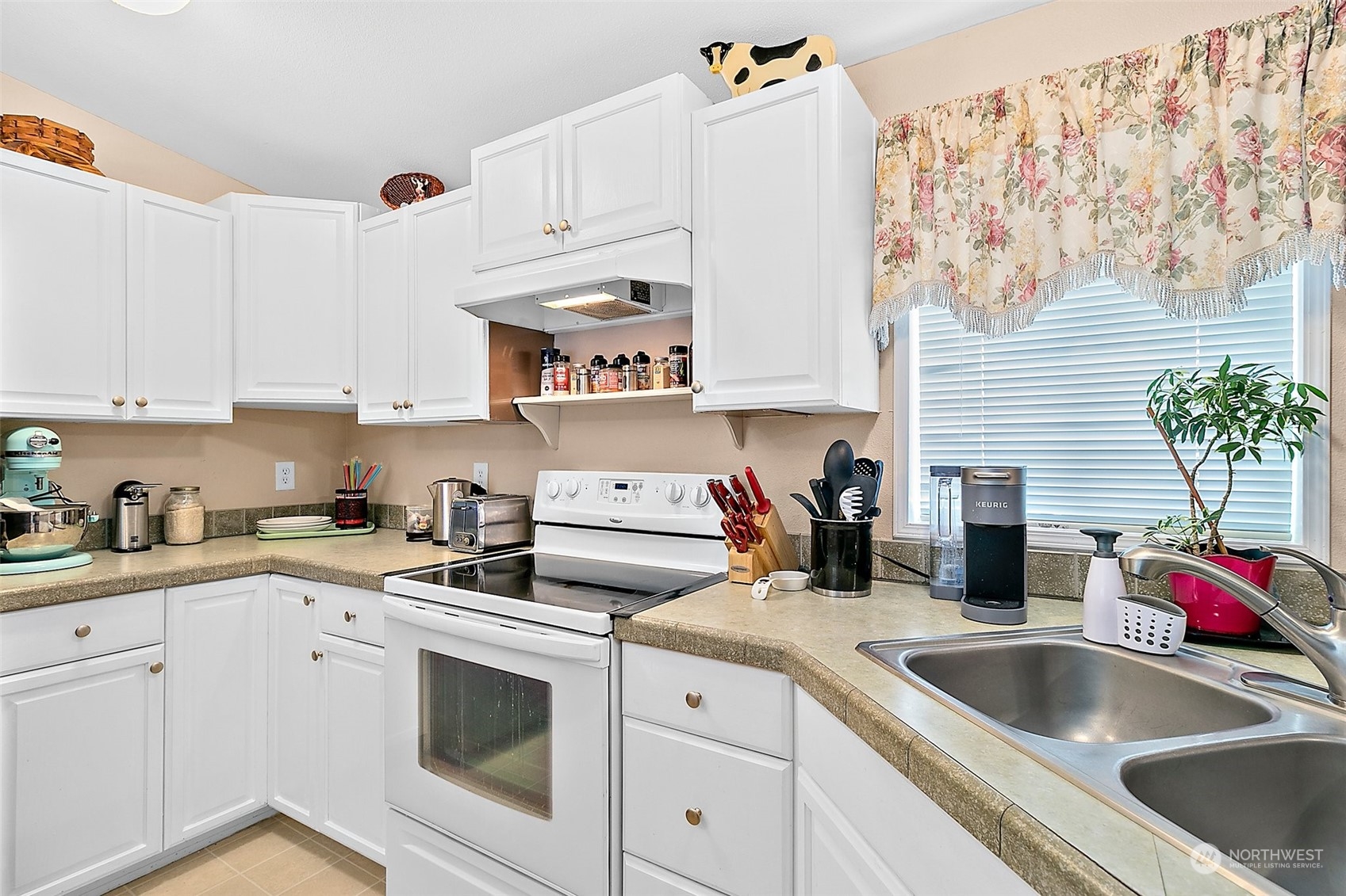 2101 South 324th Street, Unit 32 Federal Way, WA 98003 - Photo 10 of 30 a kitchen with a sink dishwasher and white cabinets