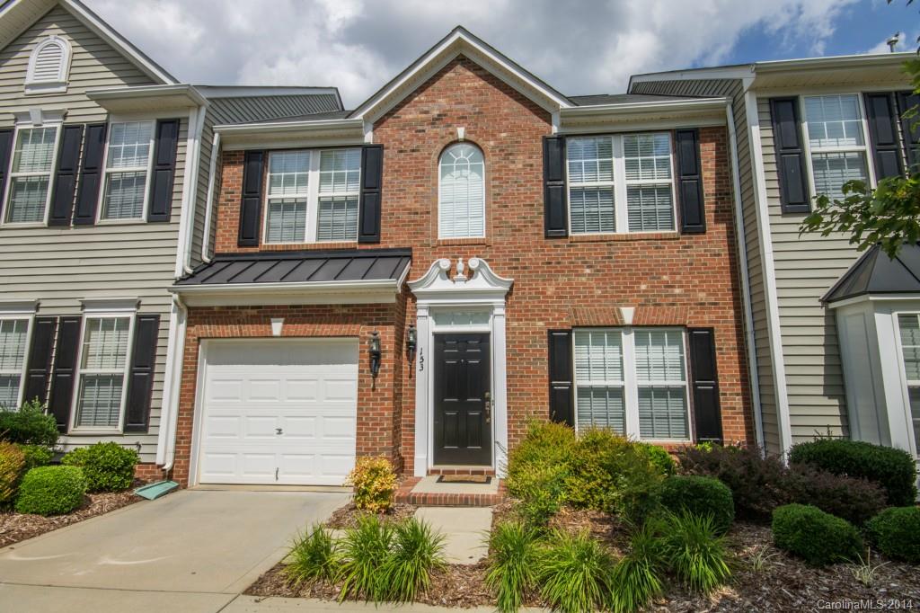 153 Snead Road, Unit 72 Fort Mill, SC 29715 - Photo 1 of 17 a front view of a house with a yard and potted plants