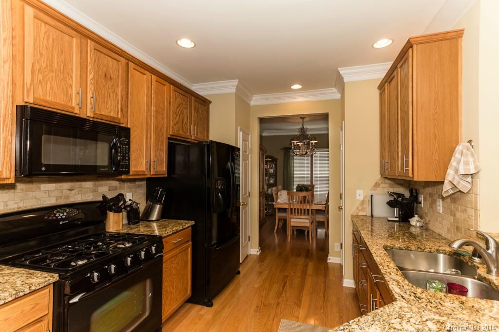 153 Snead Road, Unit 72 Fort Mill, SC 29715 - Photo 5 of 17 a kitchen with stainless steel appliances a stove a sink a microwave a refrigerator and cabinets