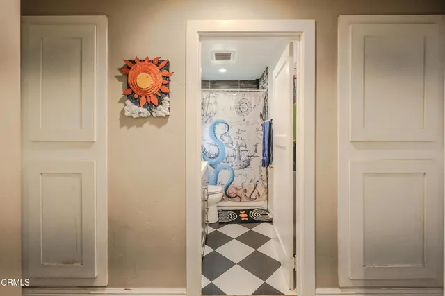 a view of a bathroom from a hallway