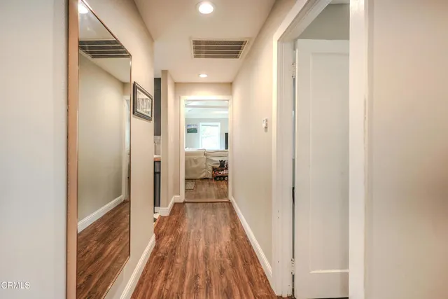 a bathroom with a sink and mirror with toilet