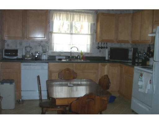 176 Phoenix Terrace Springfield, MA 01104 - Photo 4 of 7 a kitchen with a table chairs cabinets and window