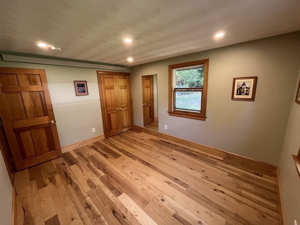 9 Clarissa Road Chelmsford, MA 01824 - Photo 7 of 19 a view of an empty room with wooden floor and a window