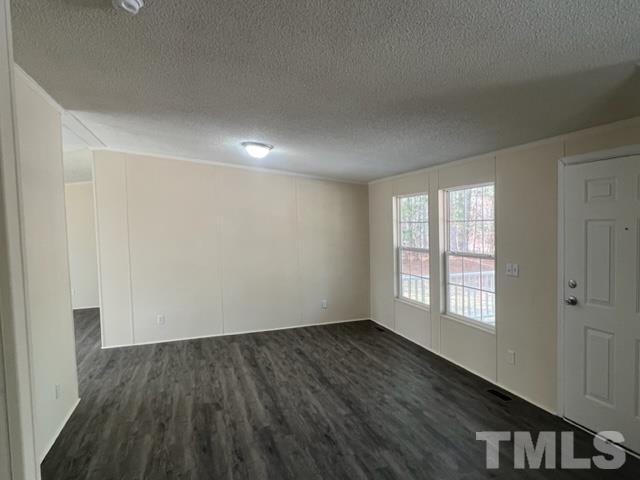 4656 Belltown Road Oxford, NC 27565 - Photo 11 of 24 a view of an empty room with wooden floor and a window