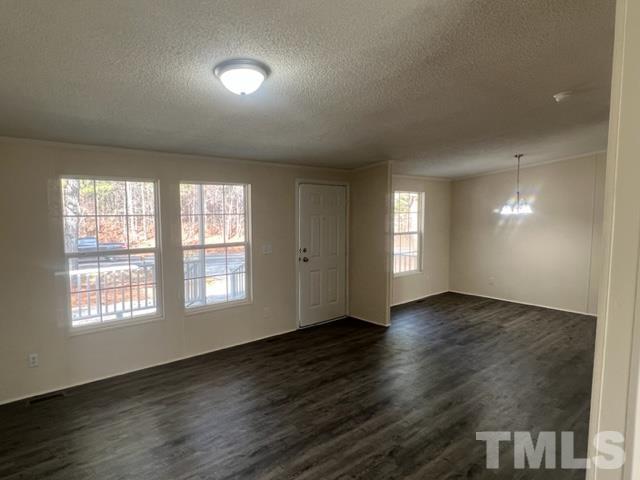 4656 Belltown Road Oxford, NC 27565 - Photo 12 of 24 an empty room with wooden floor and windows