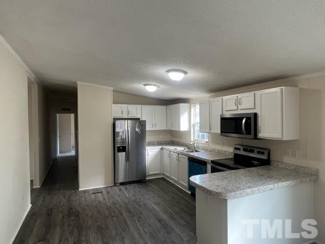 4656 Belltown Road Oxford, NC 27565 - Photo 13 of 24 a kitchen with a refrigerator and a stove top oven