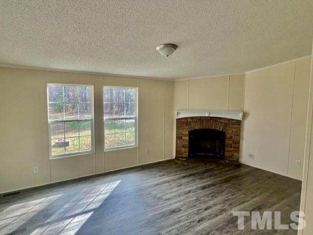4656 Belltown Road Oxford, NC 27565 - Photo 16 of 24 an empty room with wooden floor fireplace and windows