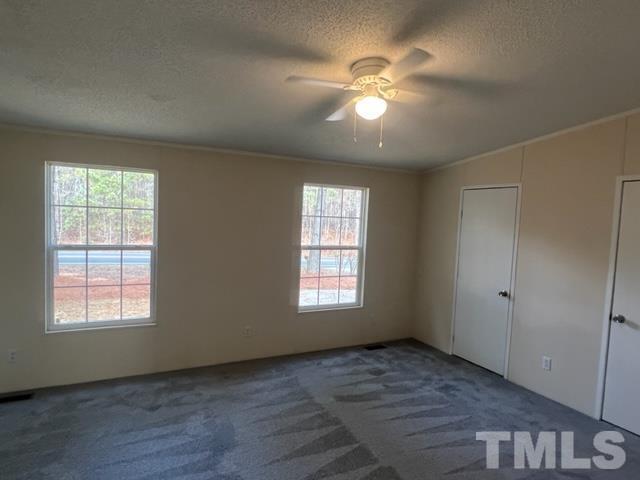 4656 Belltown Road Oxford, NC 27565 - Photo 18 of 24 an empty room with windows and chandelier fan