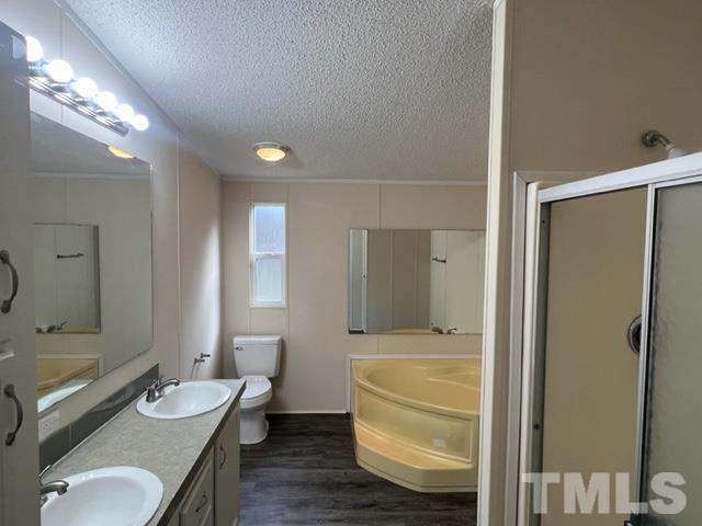 4656 Belltown Road Oxford, NC 27565 - Photo 19 of 24 a bathroom with a granite countertop sink toilet a mirror and shower