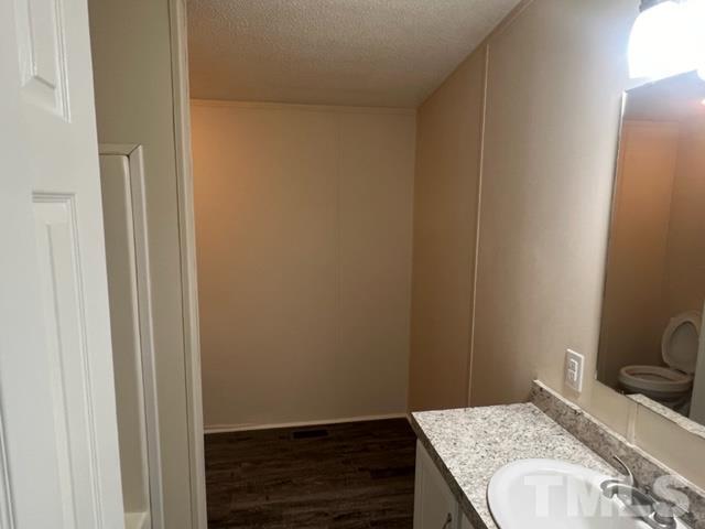 4656 Belltown Road Oxford, NC 27565 - Photo 21 of 24 a bathroom with a granite countertop sink and a vanity