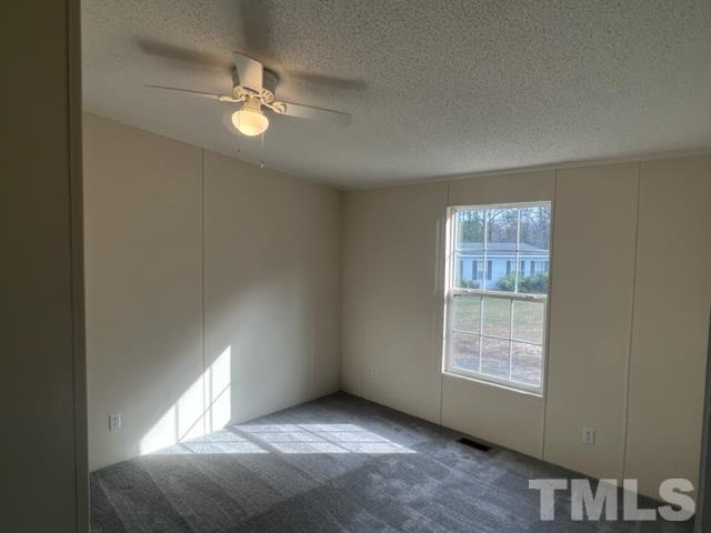 4656 Belltown Road Oxford, NC 27565 - Photo 22 of 24 an empty room with windows and fan