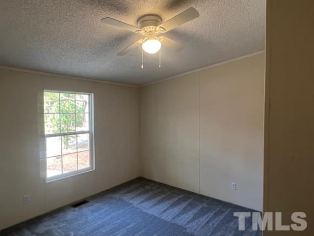 4656 Belltown Road Oxford, NC 27565 - Photo 23 of 24 an empty room with a window and a fan