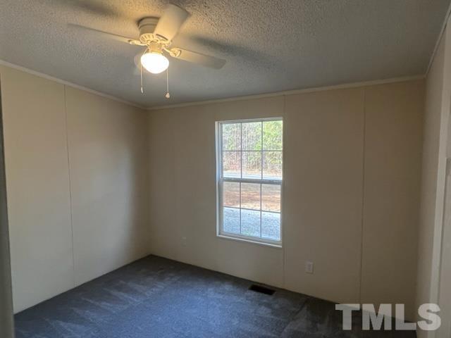 4656 Belltown Road Oxford, NC 27565 - Photo 24 of 24 an empty room with windows and fan