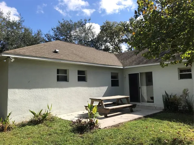 a view of a backyard with a sitting area