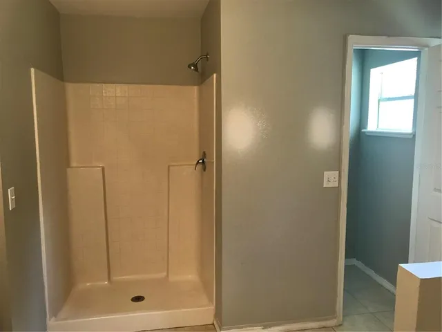 a bathroom with a glass shower door
