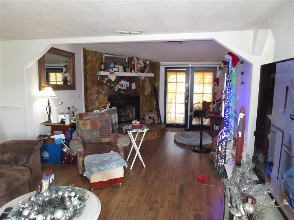 17609 Bathurst Avenue Spring Hill, FL 34610 - Photo 13 of 60 a living room with furniture and a flat screen tv