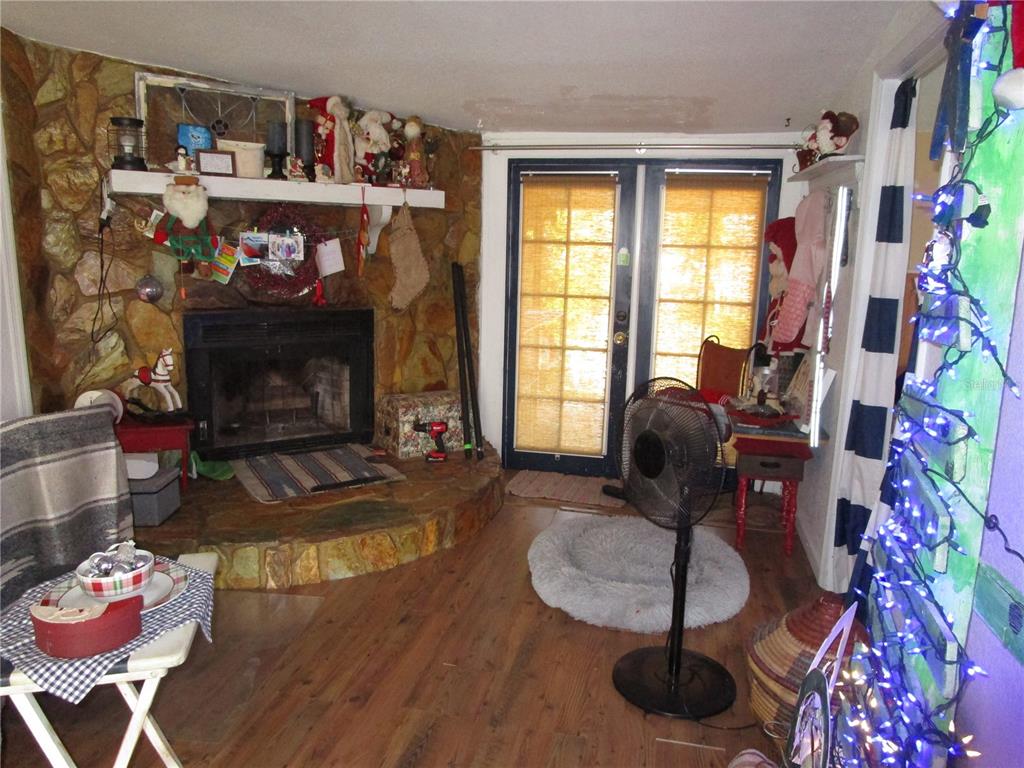 17609 Bathurst Avenue Spring Hill, FL 34610 - Photo 16 of 60 a living room with furniture and a fireplace