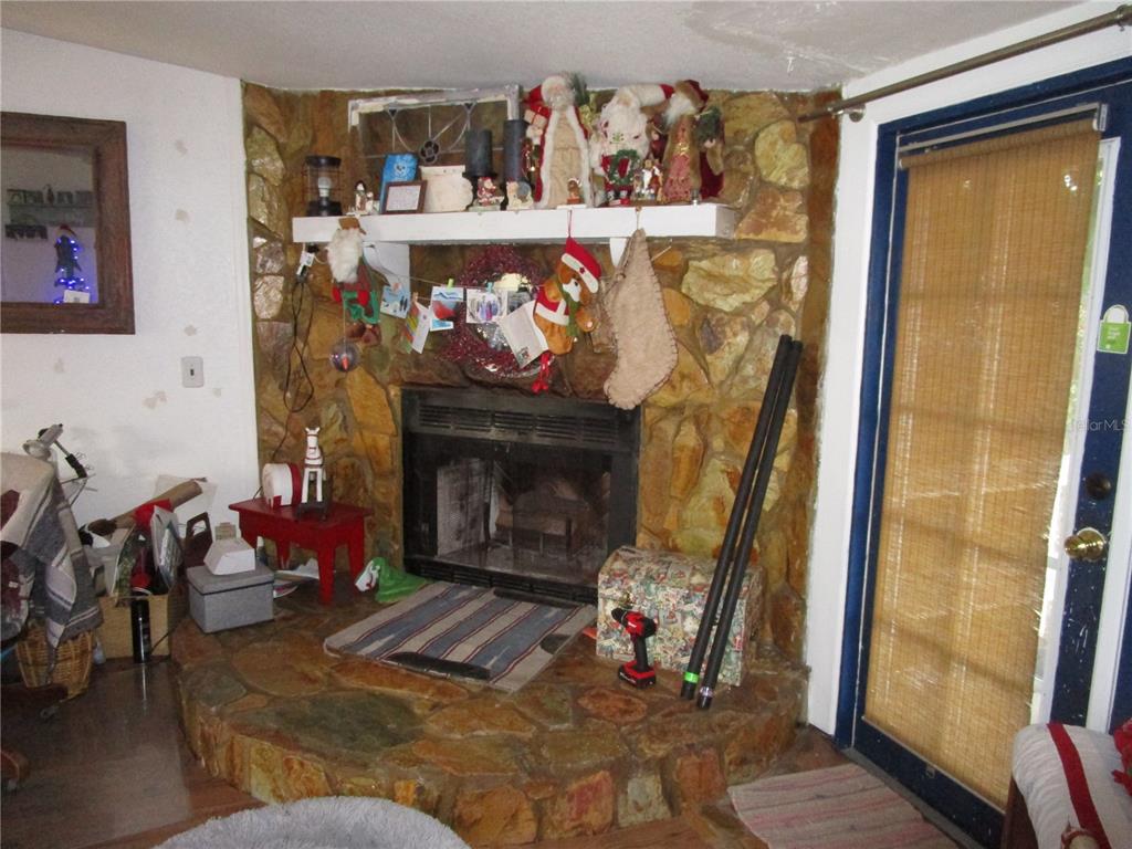 17609 Bathurst Avenue Spring Hill, FL 34610 - Photo 20 of 60 a living room with furniture and a fireplace
