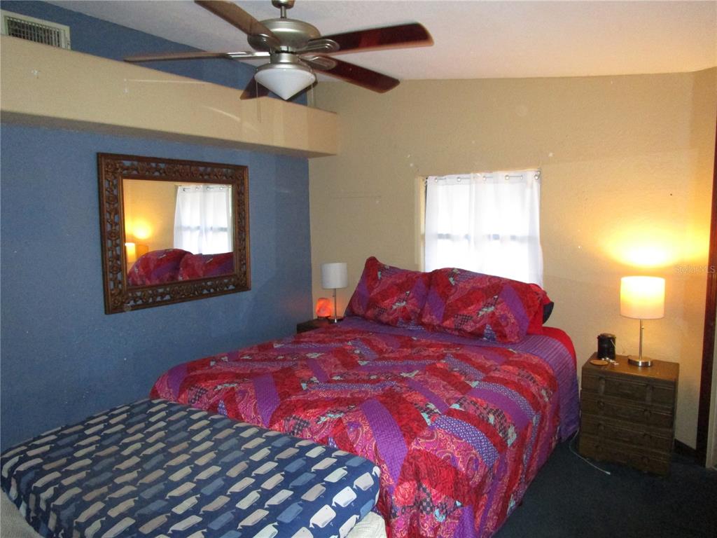 17609 Bathurst Avenue Spring Hill, FL 34610 - Photo 21 of 60 a bedroom with a bed and a window