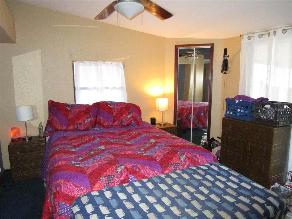 17609 Bathurst Avenue Spring Hill, FL 34610 - Photo 22 of 60 a large bed sitting in a bedroom next to a window