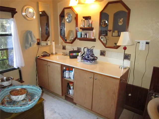 a living room with furniture and a mirror