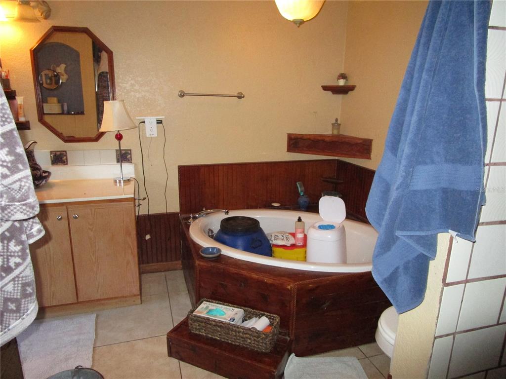 17609 Bathurst Avenue Spring Hill, FL 34610 - Photo 28 of 60 a living room with furniture and a mirror