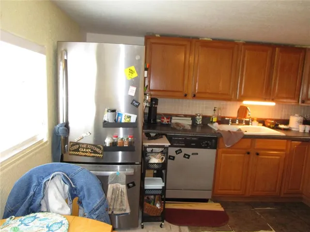 a kitchen with a sink cabinets and window